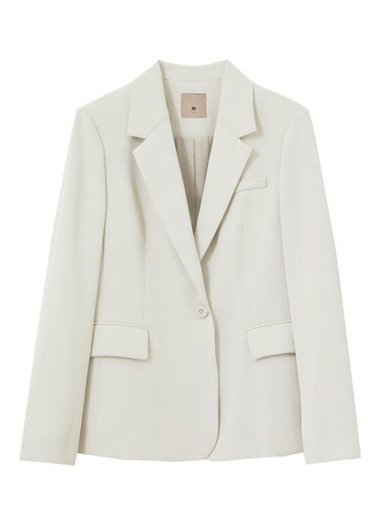 Bagvisning af beige blazer, vist uden model.